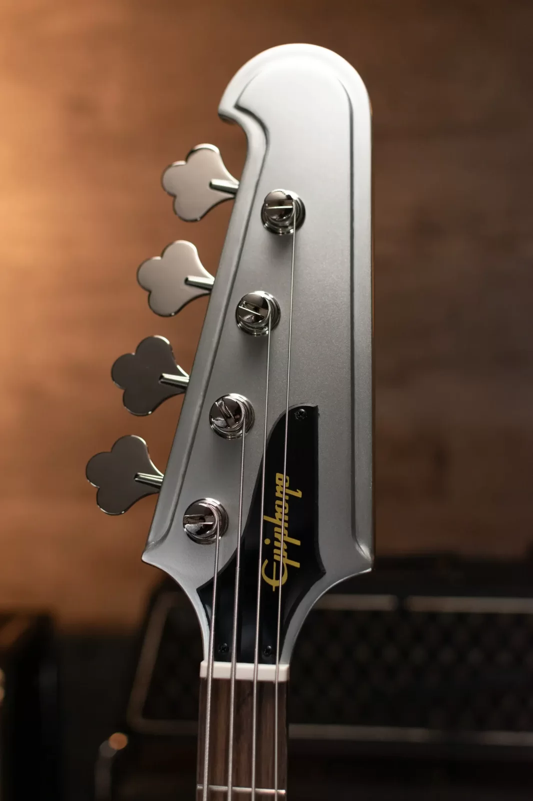 Close-up of the Thunderbird ’64 Bass headstock, featuring open-gear tuners and the iconic Epiphone logo.